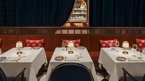 Elegant CARBONE Dubai dining room with velvet seating and lamps