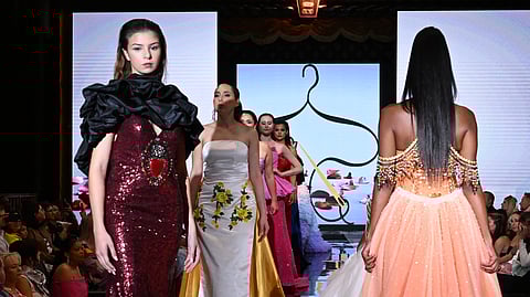 Models in couture gowns walk the runway at hiTechMODA Season 14