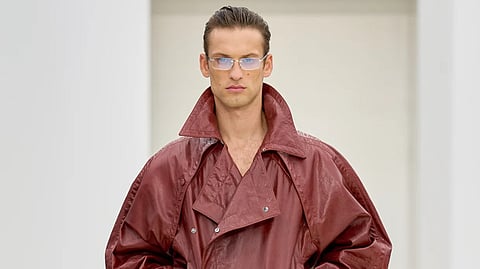 Model in oversized red leather jacket, Ferrari SS26