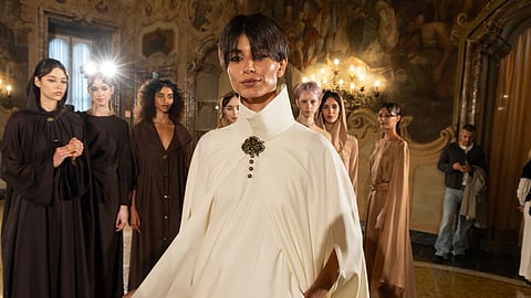 Model in ivory cape leads during Afraa Al-Noaimi’s Desert Rose show