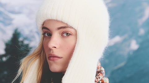 Model in white knit hat and scarf from Louis Vuitton LV Ski 2025 collection
