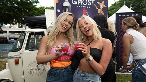 Two women enjoy pink tequila cocktails at The Tequila Festival