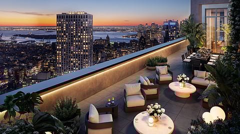 Rooftop terrace at The Brook overlooking Manhattan at sunset