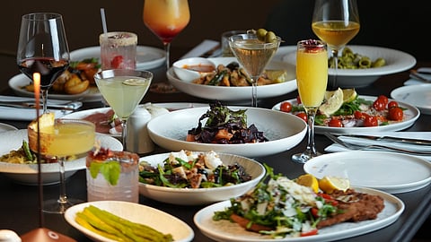 Tuscan dishes and cocktails elegantly arranged on a dining table