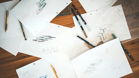 Architectural sketches and design drawings on a wooden desk