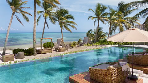 Beachfront pool with cabanas overlooking the Caribbean Sea