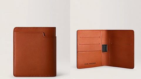 A top-view of several rich brown leather men’s wallets