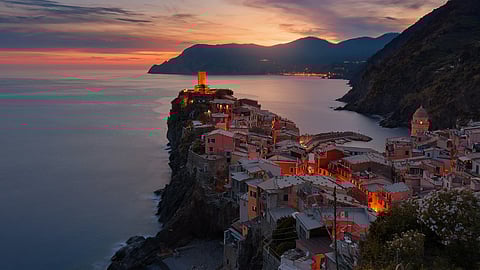 Vernazza at sunset overlooking colorful cliffs and the Mediterranean Sea