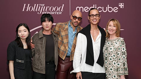 Group of artists and guests posing at The Hollywood Reporter Beauty Dinner