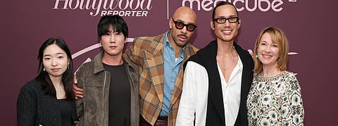 Group of artists and guests posing at The Hollywood Reporter Beauty Dinner