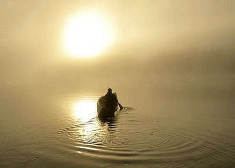 Paddling a canoe at Camp Arowhon at sunrise