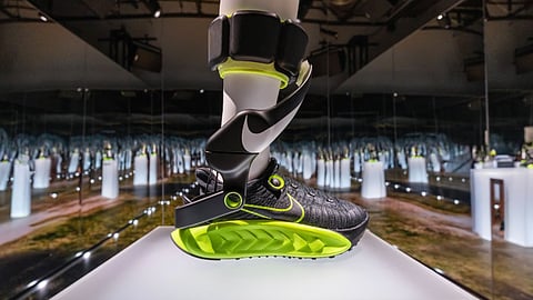 Nike Project Amplify powered shoe displayed in a mirrored exhibition space