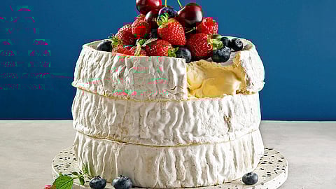 Large d’affinois cheese wheel topped with fresh berries
