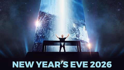 David Guetta stands onstage before a glowing geometric tower at Fontainebleau