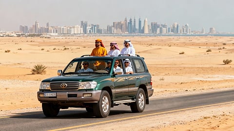 SUV driving through the Qatar desert with the Doha skyline in the background