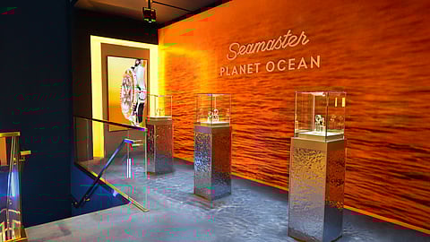 Omega Planet Ocean watches displayed in an immersive orange-lit installation at Miami Art Week