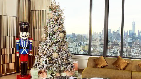 Nutcracker and decorated holiday tree overlooking the New York skyline in the Grand Holiday Suite