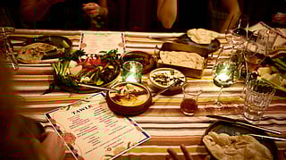 A shared tawle feast with dips, flatbread, and small plates at Maydan in Los Angeles