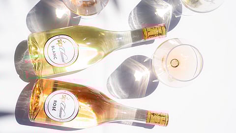 Sip Channé Blanc and Rosé bottles with glasses in bright sunlight