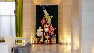 Colorful sculptural holiday installation displayed in the lobby of an EDITION hotel