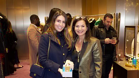 Veronique Gabai with Marion Magnuson receiving an engraved Golden Oud bottle at Printemps NYC