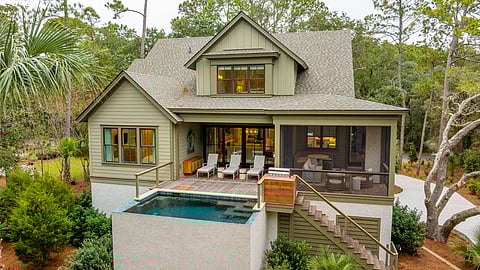 Exterior of a luxury Pacaso home on Kiawah Island featuring a private pool and patio seating