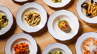 Overhead view of handmade pasta dishes at Rezdôra and Massara on Park