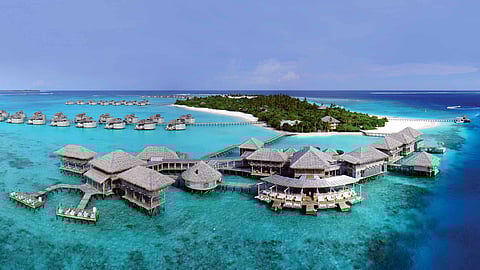 Overwater villas at Six Senses Laamu surrounded by turquoise waters in Laamu Atoll, Maldives