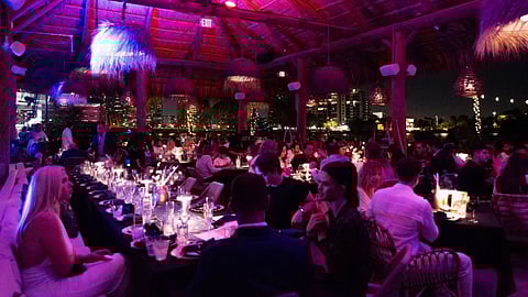 New Year’s Eve dinner at Joia Beach Miami with candlelit tables and waterfront views