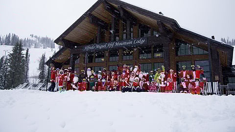 Santas and other holiday characters gather at Mid-Mountain Lodge