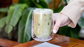 Iced matcha latte in a double-walled glass set on a table at Il Giardino at Mr. C Miami