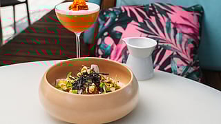 Mediterranean seafood and vegetable dishes served on ceramic plates at Aguasal Miami Beach