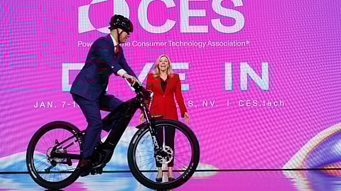 Presenter and cyclist on stage at CES 2026 highlighting future mobility and transport innovation