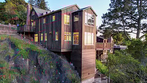 Cantilevered house built into a steep hillside with elevated living areas