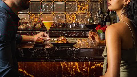 Couple enjoying cocktails at Jo’s Bar, the reimagined luxury lobby bar at The Setai, Miami Beach