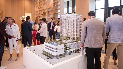 Guests view a scale model of a luxury North Beach condominium development in Miami Beach