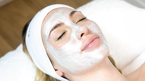 Client relaxes with a hydrating facial mask during a Silver Mirror treatment in Coral Gables
