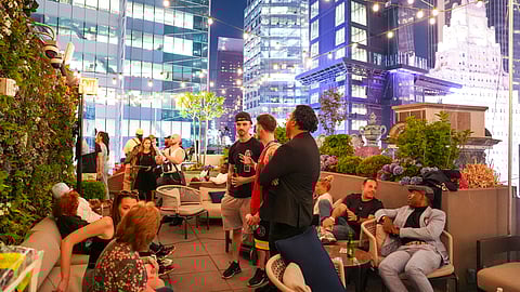 Guests mingling at a private rooftop event overlooking Times Square in New York City