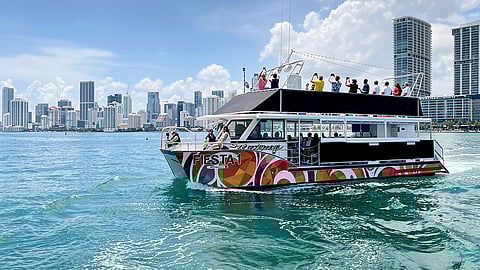 Tour boat cruising on Biscayne Bay with Miami’s downtown skyline in the background