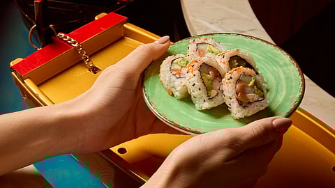 Grabbing sushi from the sushi river at Tokyo Tuna in South Miami