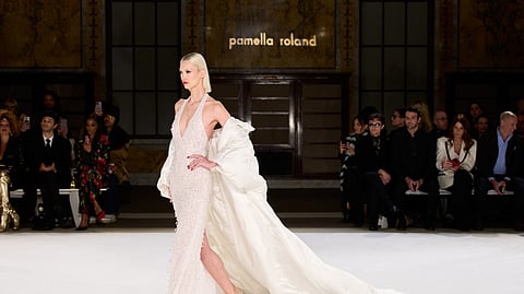 Model in crystal-embroidered halter gown and satin opera coat at Pamella Roland FW26 runway show
