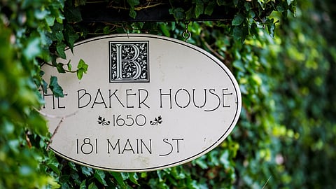 The Baker House 1650 sign at 181 Main Street framed by green ivy in East Hampton