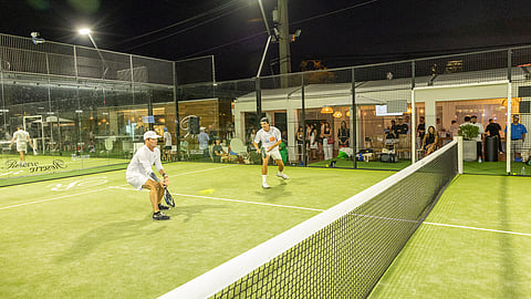 Players compete in a nighttime charity padel match at Reserve Padel Miami