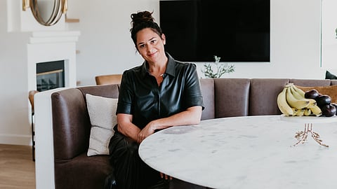 Antonia Lofaso seated at a marble table inside her Los Angeles home