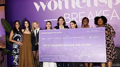 Group on stage holds $50,000 check for Women of Tomorrow at Women’s Power Breakfast