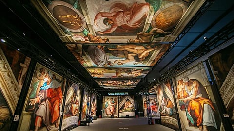 Wide interior view of the exhibition with ceiling and wall fresco reproductions