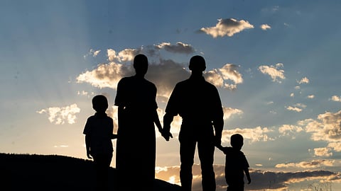 Silhouette of a family at sunset symbolizing generational wealth, legacy planning, and family values