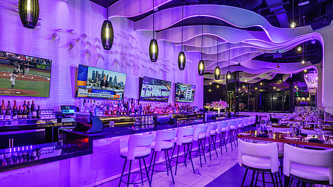 Bar area at STK Westwood with illuminated counter, ceiling ribbons, and lounge seating