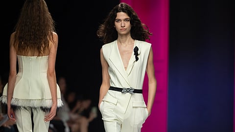 Model wearing ivory tailored vest and trousers on the Genny fall winter 2026 runway