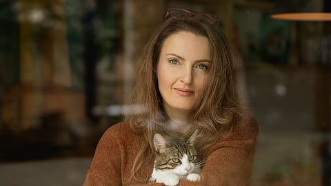 Rositsa Petrova holding a cat, founder of Home of Wool